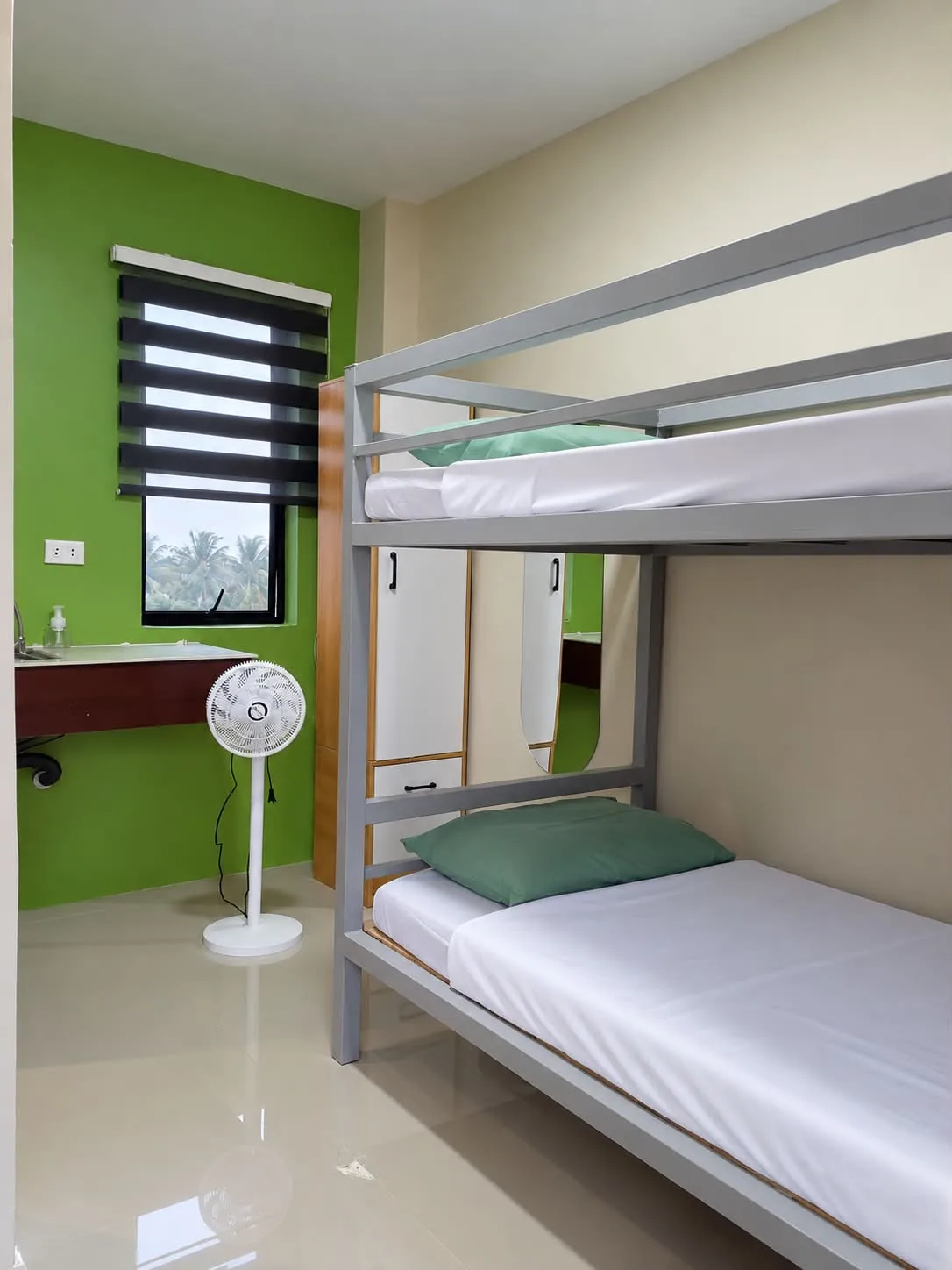 Bunk beds, fan and room sink at Rohan’s Boarding House in Alae, Manolo Fortich