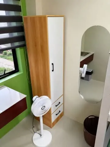 Wardrobe, mirror and standing fan at Rohan’s Boarding House in Alae, Manolo Fortich